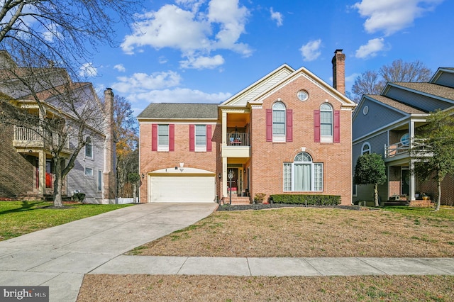 view of front property featuring a balcony, a garage, and a front lawn