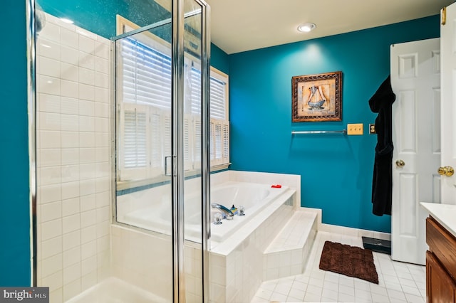 bathroom with tile patterned floors, vanity, and shower with separate bathtub