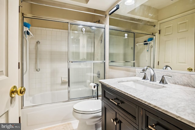 full bathroom featuring vanity, toilet, and combined bath / shower with glass door