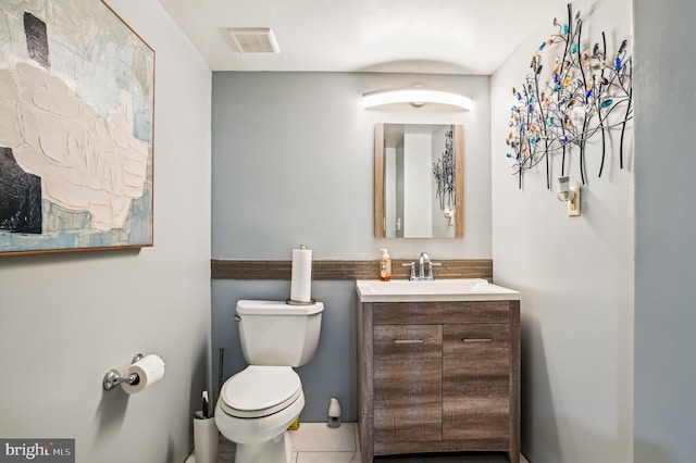 bathroom with tile patterned floors, vanity, and toilet