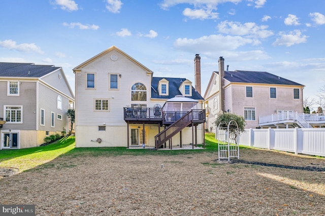 rear view of property featuring a wooden deck