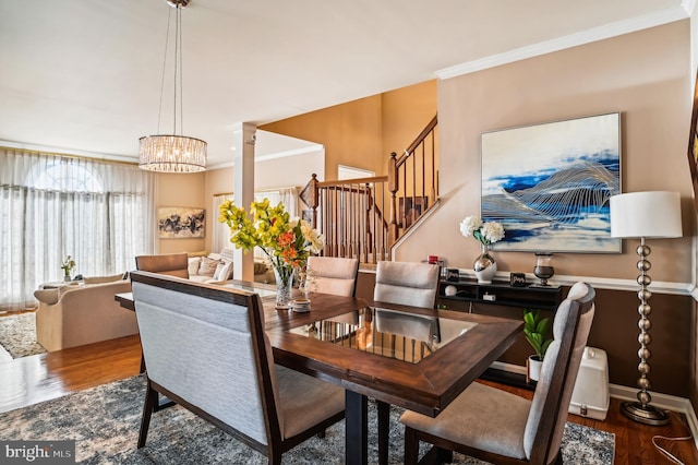 dining area featuring wood-type flooring and ornamental molding