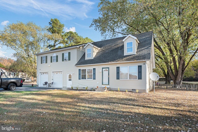 cape cod-style house featuring a garage and a front lawn