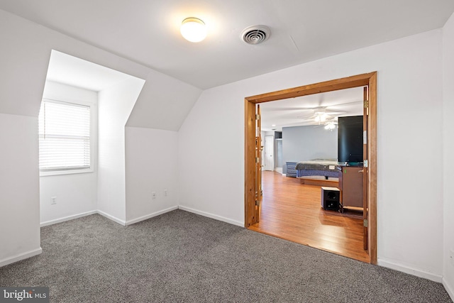 bonus room with dark hardwood / wood-style floors, ceiling fan, and lofted ceiling