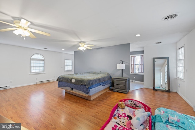 bedroom featuring multiple windows, ceiling fan, and light hardwood / wood-style floors