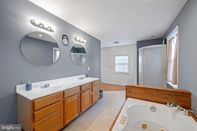 bathroom with tile patterned floors, vanity, and shower with separate bathtub