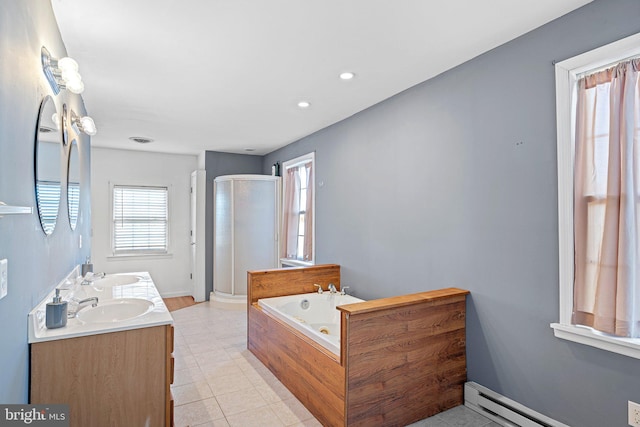 bathroom featuring tile patterned flooring, shower with separate bathtub, vanity, and baseboard heating