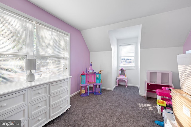 playroom featuring dark colored carpet and lofted ceiling