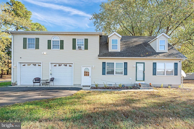 view of front of house with a front yard, a garage, and cooling unit