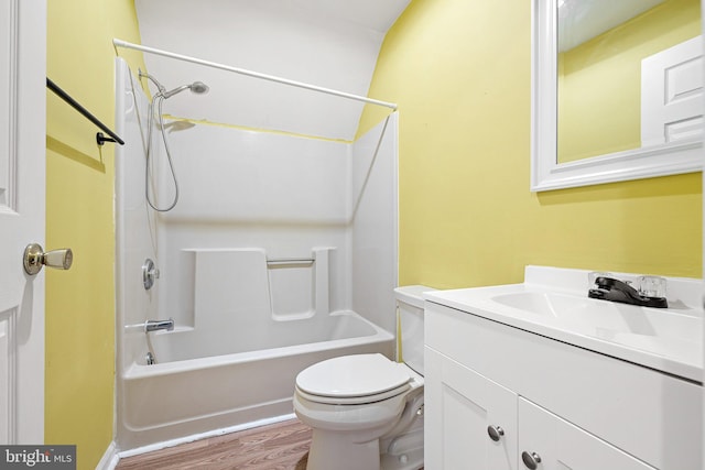 full bathroom featuring hardwood / wood-style floors, vanity,  shower combination, and toilet