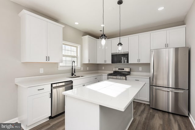 kitchen with a center island, sink, stainless steel appliances, and dark wood-type flooring