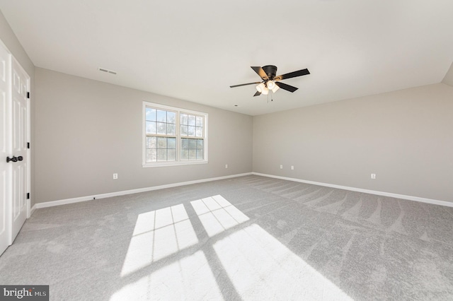 carpeted spare room featuring ceiling fan