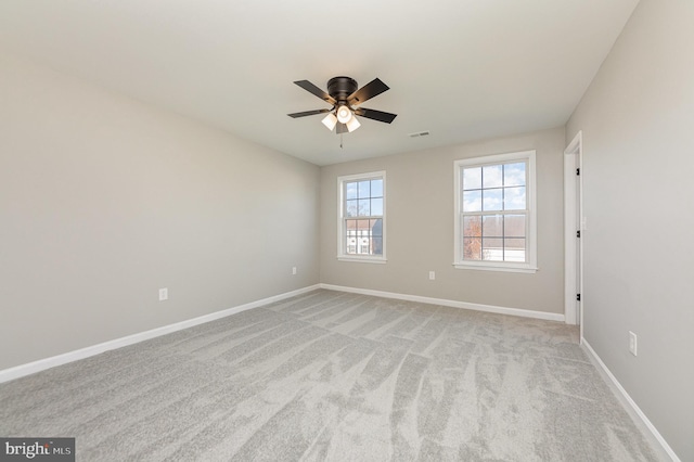 unfurnished room with light carpet and ceiling fan