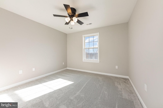 spare room featuring ceiling fan and carpet floors