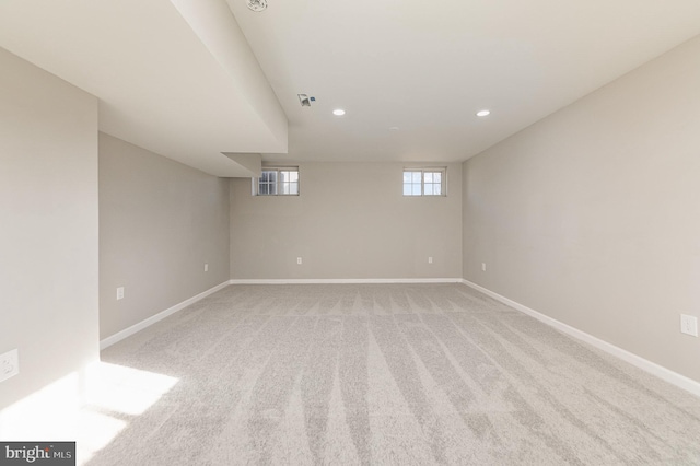 spare room featuring light colored carpet