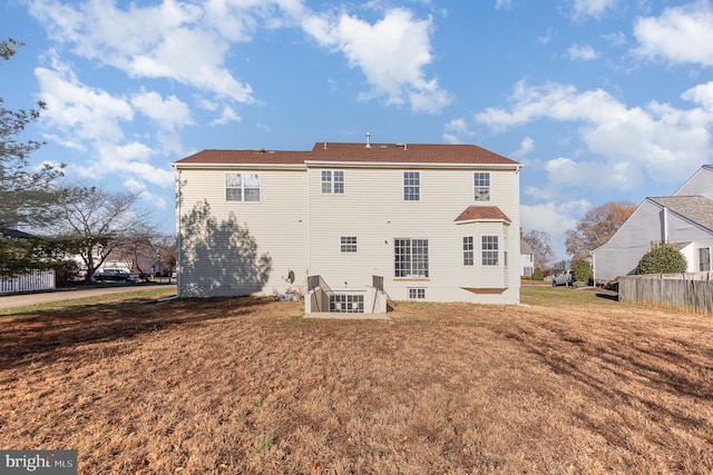 back of house featuring a lawn