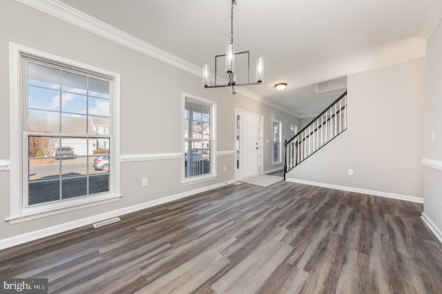 entrance foyer featuring crown molding, dark hardwood / wood-style floors, and an inviting chandelier