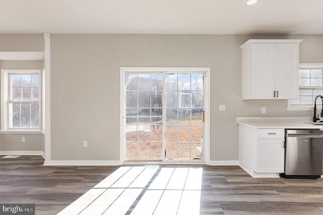 kitchen with dishwasher, white cabinets, and a wealth of natural light