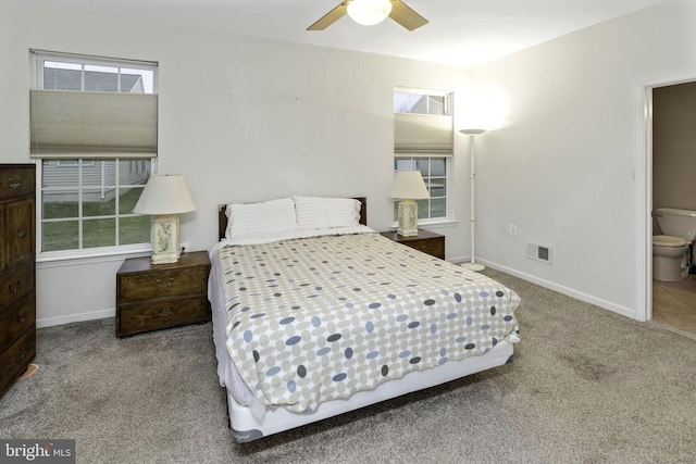 bedroom featuring ensuite bath, ceiling fan, and carpet floors