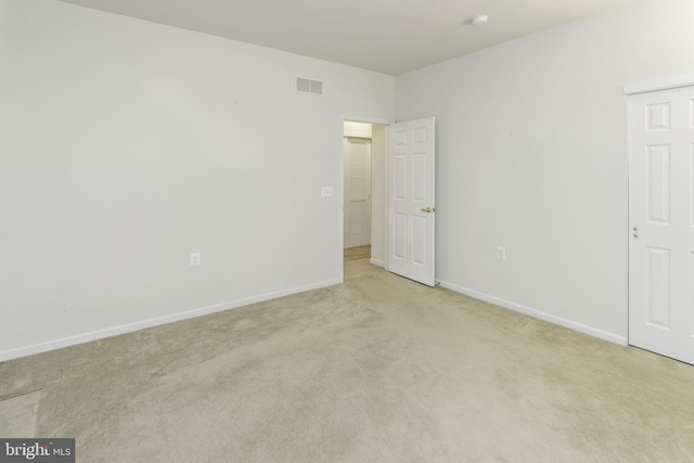 empty room featuring light carpet