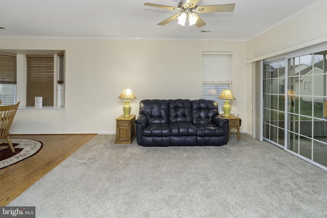 living room featuring hardwood / wood-style flooring, ceiling fan, and ornamental molding