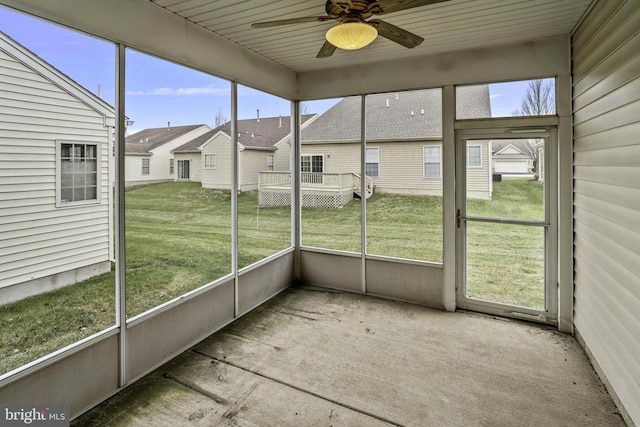 unfurnished sunroom featuring a wealth of natural light and ceiling fan