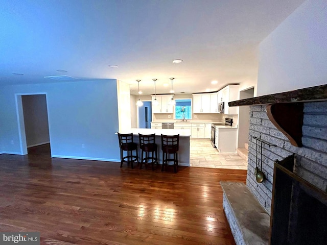 living room with wood-type flooring and sink