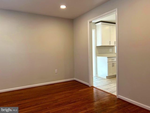 empty room featuring dark hardwood / wood-style flooring