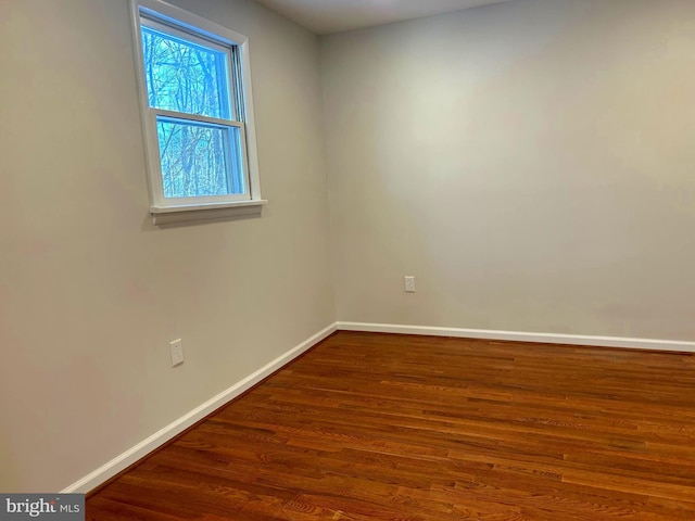 spare room featuring dark hardwood / wood-style flooring