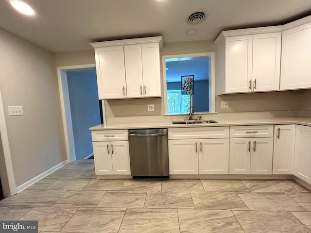 kitchen with stainless steel dishwasher, white cabinets, and sink