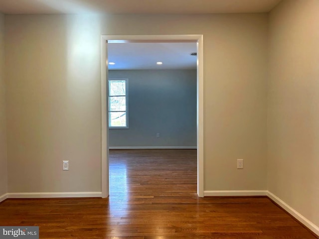 empty room with dark wood-type flooring