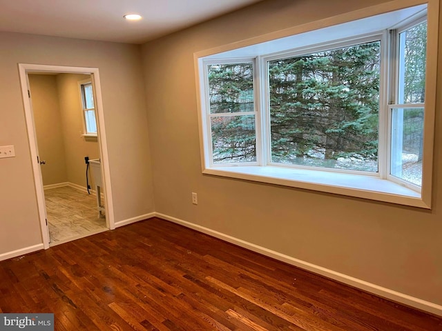 unfurnished room with wood-type flooring