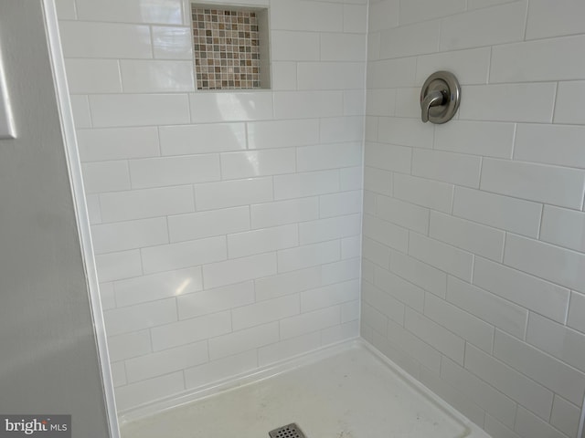 bathroom with a tile shower