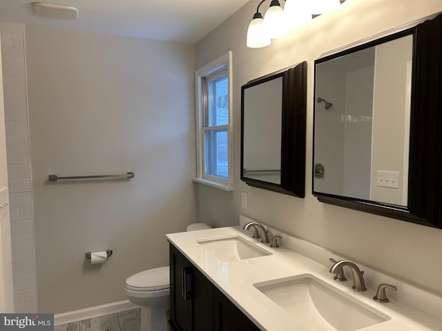 bathroom featuring tile patterned floors, vanity, and toilet