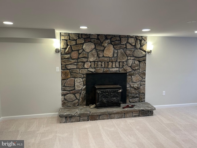 interior details featuring carpet floors and a wood stove