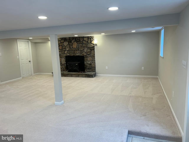 basement featuring a fireplace and light colored carpet