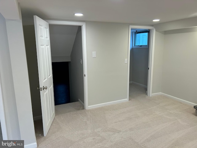 basement featuring light carpet