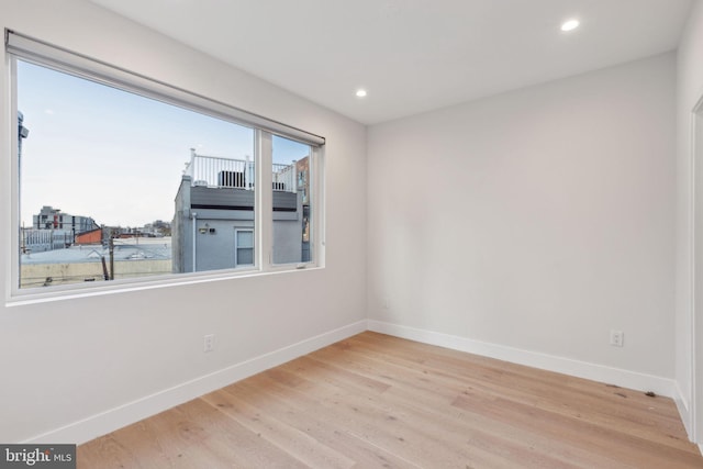 unfurnished room featuring light hardwood / wood-style floors