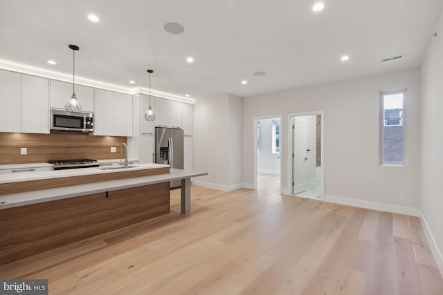 1610 Germantown Ave Unit C, Philadelphia, PA 19122 - kitchen with stainless steel appliances, recessed lighting, tasteful backsplash, light countertops, and light wood-style flooring