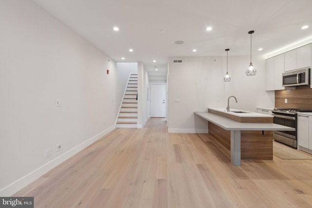 1610 Germantown Ave Unit C, Philadelphia, PA 19122 - kitchen with stainless steel appliances, white cabinets, recessed lighting, light countertops, and modern cabinets
