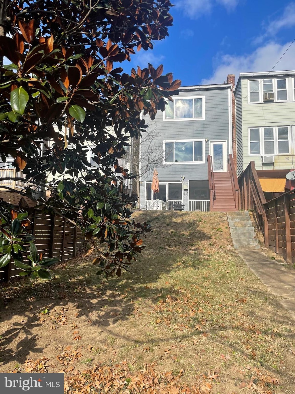 rear view of house featuring a yard