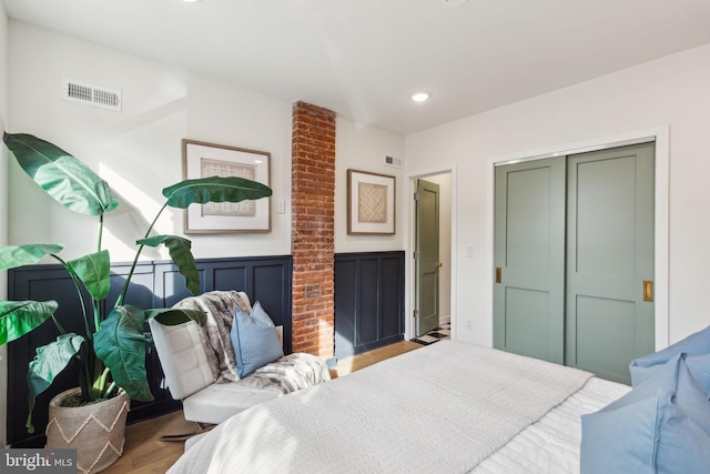 bedroom featuring light hardwood / wood-style flooring and a closet