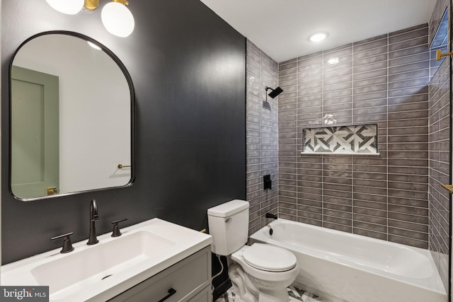 full bathroom with vanity, tiled shower / bath combo, and toilet