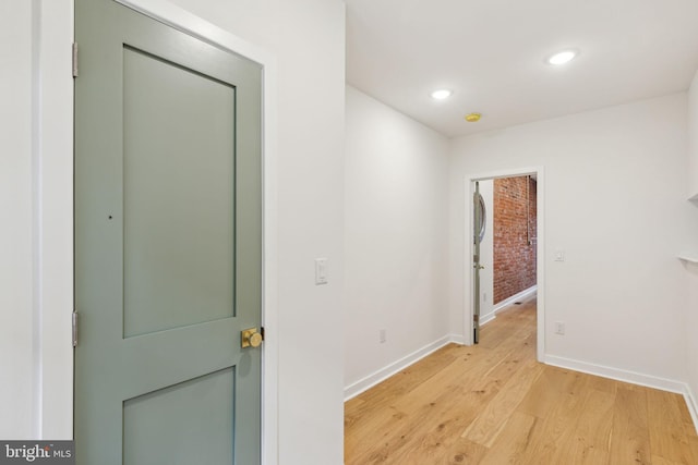 corridor with light hardwood / wood-style flooring