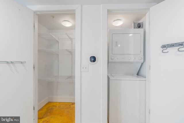 laundry room with laundry area and stacked washer / dryer