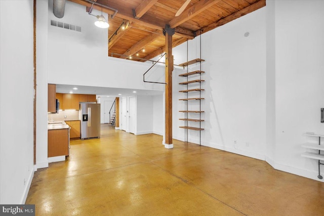 unfurnished living room with wooden ceiling, visible vents, baseboards, stairway, and finished concrete floors