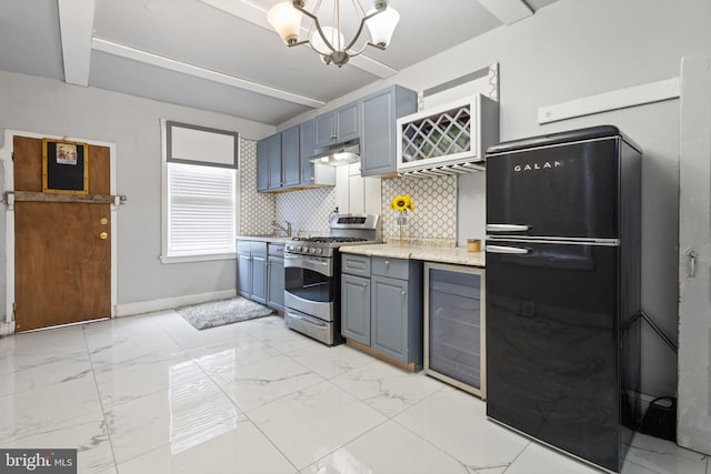 kitchen with gas range, beverage cooler, tasteful backsplash, black fridge, and beamed ceiling