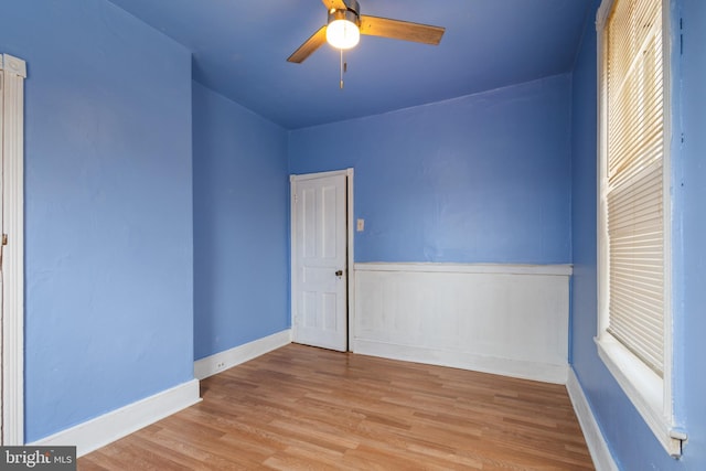 empty room with light wood-type flooring and ceiling fan