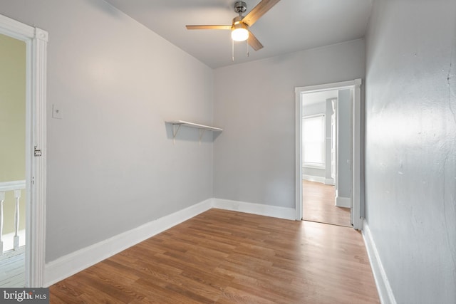 empty room with light wood-type flooring and ceiling fan