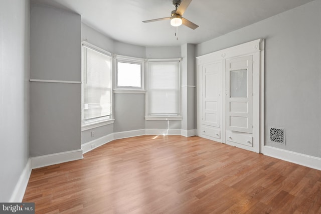 unfurnished bedroom with ceiling fan and light wood-type flooring